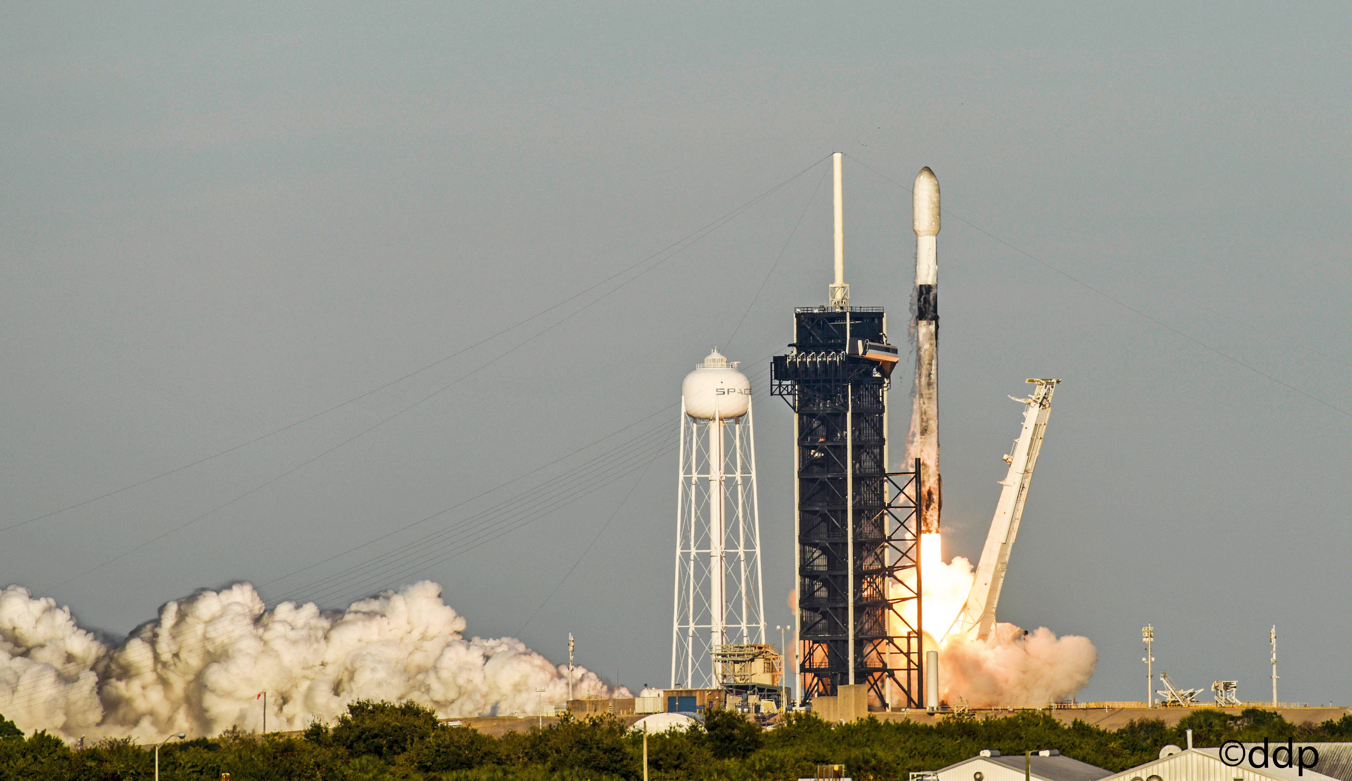 The launch of a SpaceX Falcon 9 rocket carrying satellites