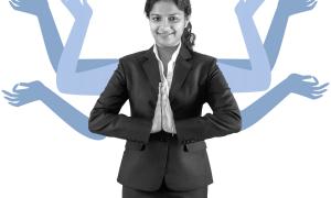 A young professional  Indian woman greeting with 'Namaste'.