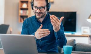 man taking part in a video conference at home