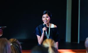 Girl speaking to an attentive audience