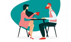 A man and a woman sitting at a table drinking coffee