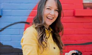 Lauren Psyk pictured in front of a colourful wall