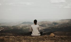 A woman meditating in the mountains