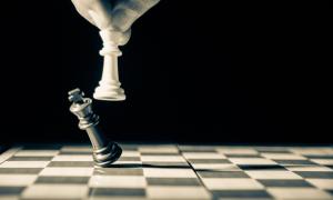 Player knocking over final chess piece of opponent