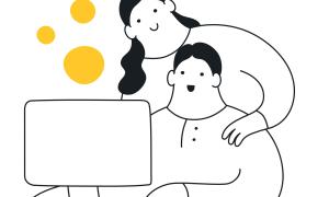 Colleagues talking at one of their desks with a laptop