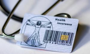 A health insurance card and stethoscope