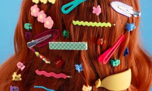 red hair filled with a diverse assortment of hair slides and clips