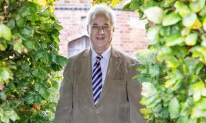 Adrian Fisher standing in a garden