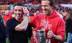 Ryan Reynolds and Rob McElhenney co owners of Wrexham with the trophy during the Sky Bet League One match between Wrexham AFC and Charlton Athletic FC at Racecourse Ground on April 26, 2025 in Wrexham, Wales.