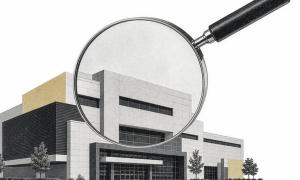 An illustration of a magnifying glass focused in on an office building