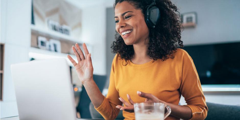 Frau mit Headset vor dem Laptop