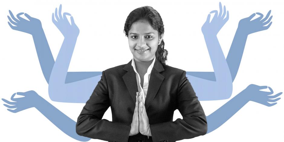 A young professional  Indian woman greeting with 'Namaste'.