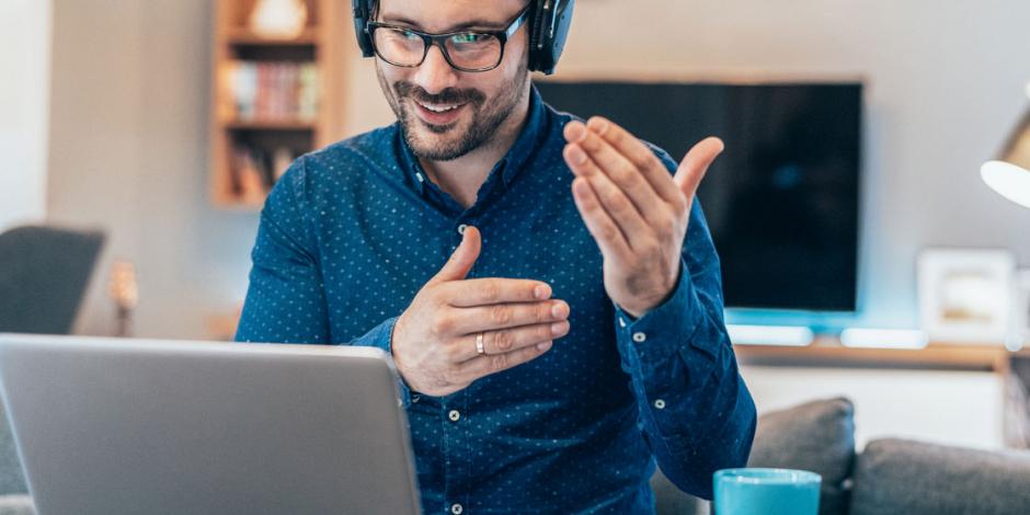 man taking part in a video conference at home