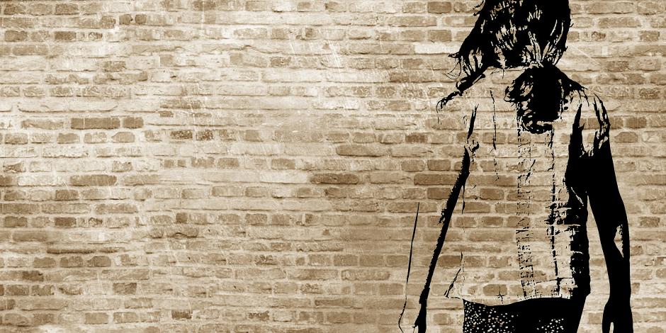 : Graffiti/shadow on a brickwall showing a refugee girl walking with her suitcase
