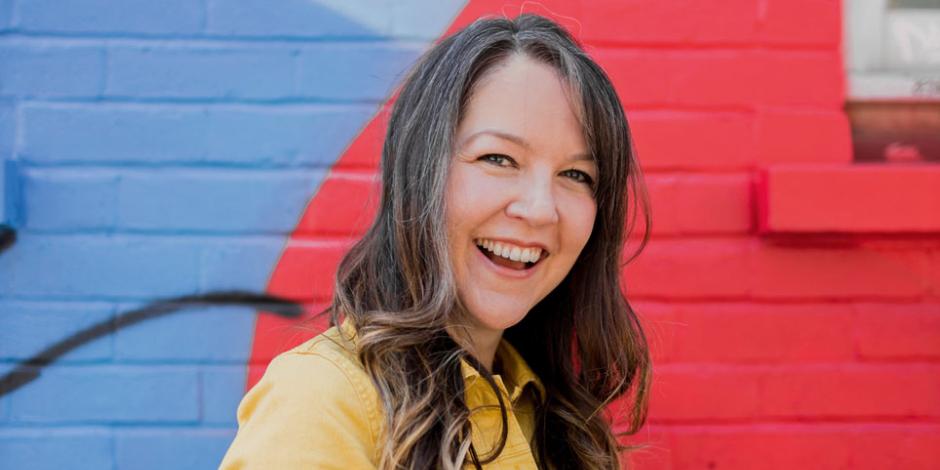 Lauren Psyk pictured in front of a colourful wall