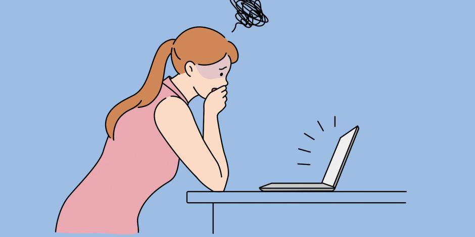 A woman looking worried in front of her computer