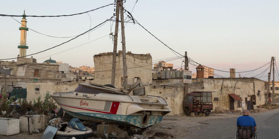 A boat sits atop a rubbish pile in a city in Lebanon