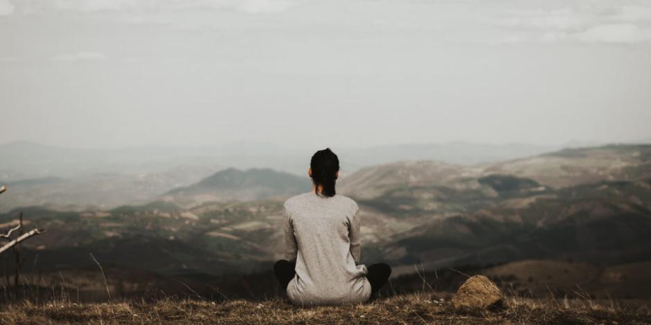 A woman meditating in the mountains