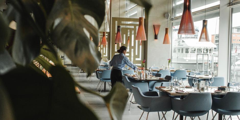 server setting the tables in a restaurant