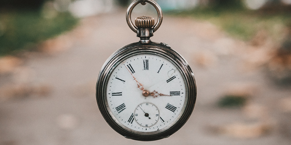 pocket watch hanging in the air with path in the background