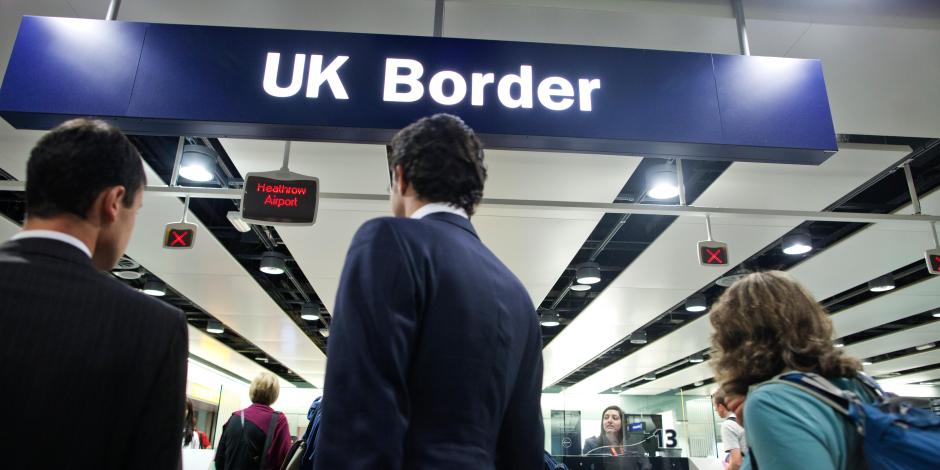 Travelers waiting at the UK border at Heathrow Airport