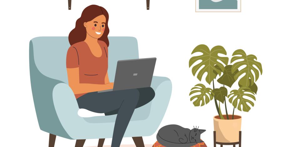 Woman sitting on her comfy chair at home, working on her laptop with her cat cozied up at her feet