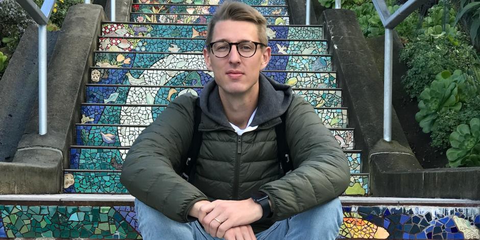 Pius Binder sitting on a set of colorful steps outdoors