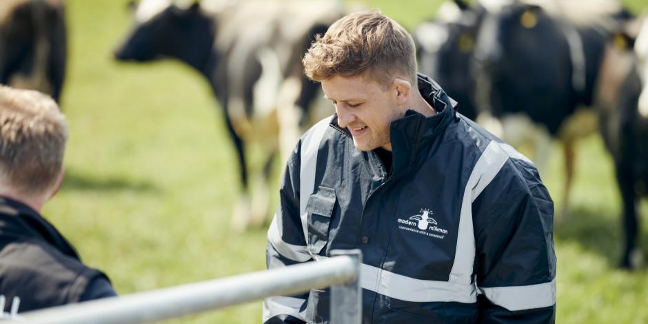 Simon Mellin, The Modern Milkman, surrounded by cows at a farm