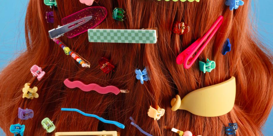 red hair filled with a diverse assortment of hair slides and clips