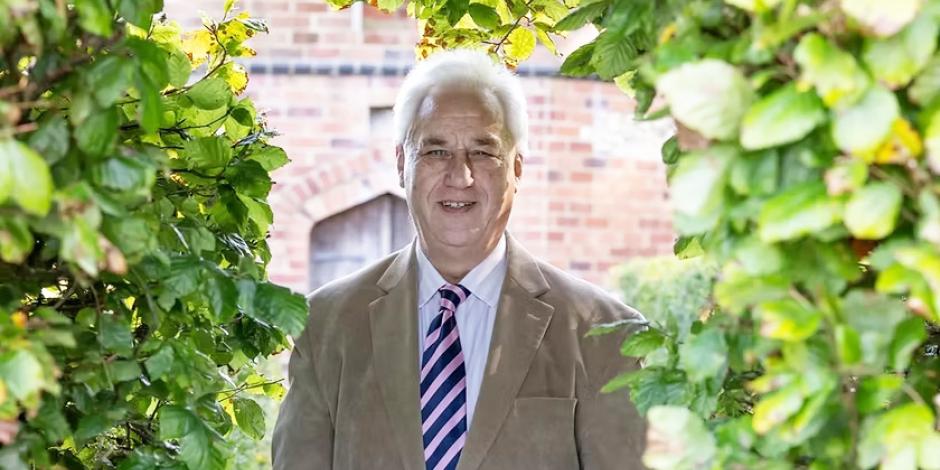 Adrian Fisher standing in a garden