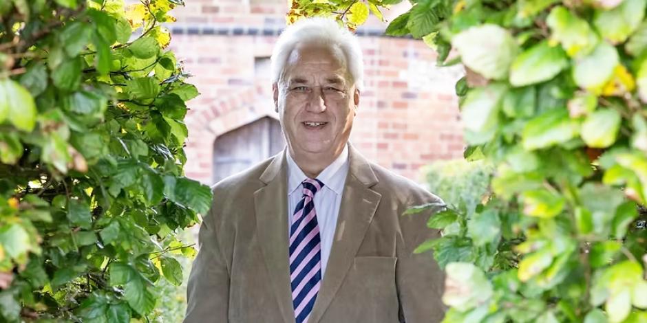 Adrian Fisher standing in a garden