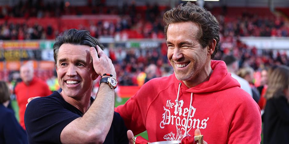 Ryan Reynolds and Rob McElhenney co owners of Wrexham with the trophy during the Sky Bet League One match between Wrexham AFC and Charlton Athletic FC at Racecourse Ground on April 26, 2025 in Wrexham, Wales.