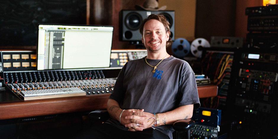 Kid Harpoon sitting at a mixing console inside a recording studio