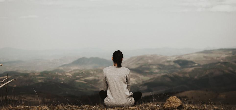 A woman meditating in the mountains