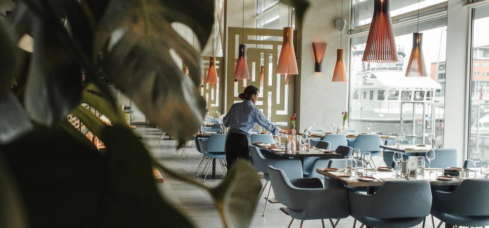 server setting the tables in a restaurant