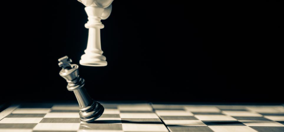 Player knocking over final chess piece of opponent