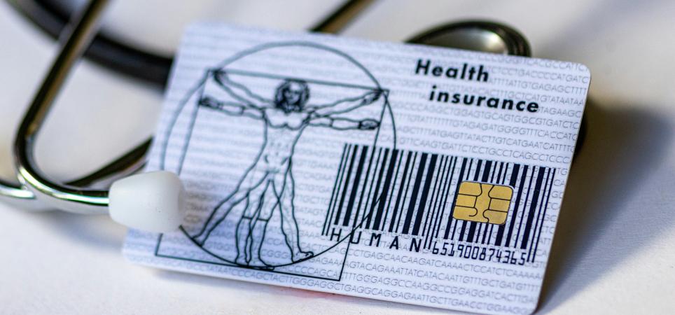 A health insurance card and stethoscope