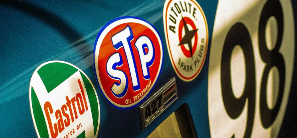 Sponsor stickers on the side of a race car.