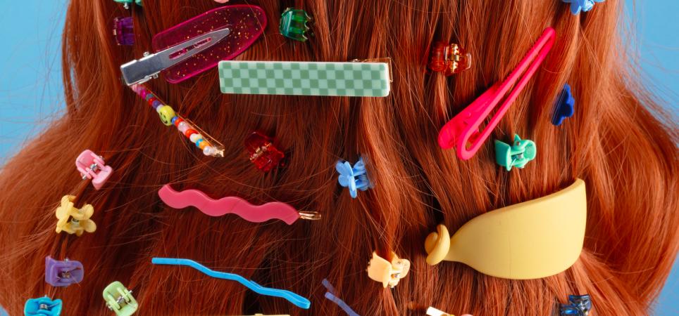 red hair filled with a diverse assortment of hair slides and clips