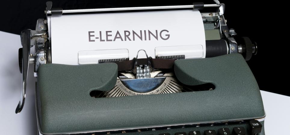 a sheet of paper that says "e-learning" on it coming out of a typewriter