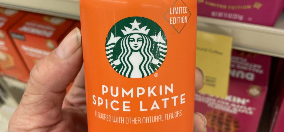 Someone holding a bottle of Starbucks Pumpkin Spice Latte iced espresso