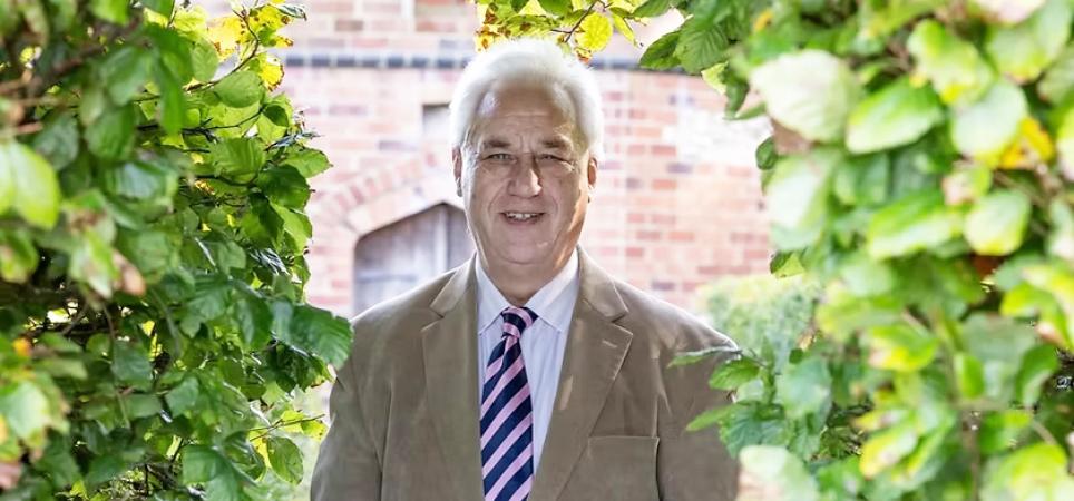 Adrian Fisher standing in a garden