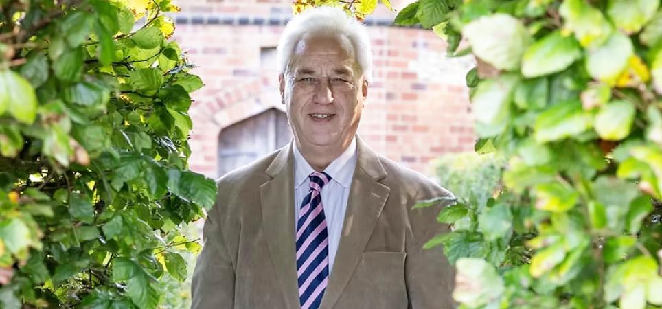 Adrian Fisher standing in a garden