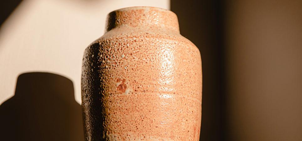 An urn standing in the shadows