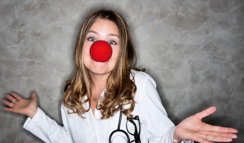 a female doctor with a clown’s nose on