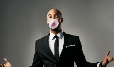 businessman blowing bubblegum