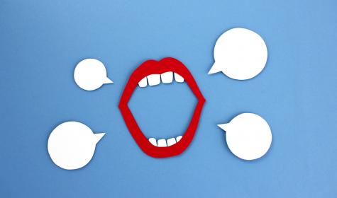 An open mouth with speech bubbles around it