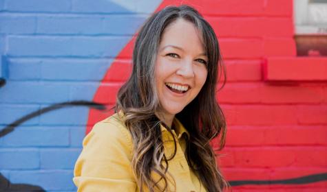 Lauren Psyk pictured in front of a colourful wall