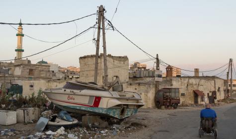 A boat sits atop a rubbish pile in a city in Lebanon