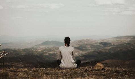 A woman meditating in the mountains